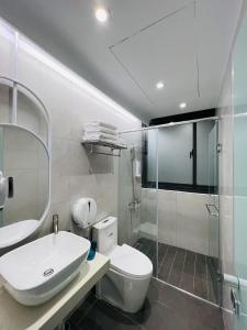 a bathroom with a toilet and a sink and a shower at Planet 23 in Chiayi City