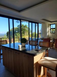 a kitchen with a large island with a table and chairs at Villa en la montaña in Jarabacoa