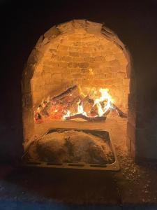 a brick oven with a food cooking in it at Suggestivo Trullo in valle d'itria in Ceglie Messapica