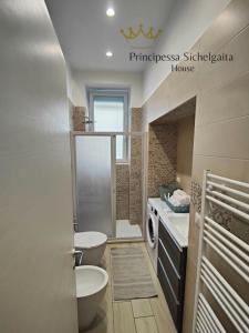 a bathroom with a toilet and a sink and a toilet istg at Principessa Sichelgaita House in Salerno