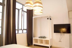a bedroom with a mirror and a bed and a tv at Apartamento FERROL VELLO II in Ferrol