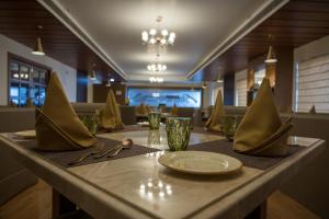 a table with a plate and napkin on top of it at Golden Retreat in Baharampur