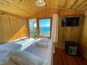 a bedroom with two beds and a large window at Tree Houses Hotel in Fethiye +37 photos