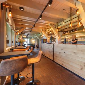 a bar with a row of tables and chairs at Frei wie der Wind-Glamping in Dierhagen