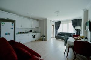 a living room with a couch and a table at EMİSSA MOTEL in Akçatepe