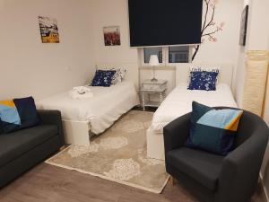 a room with two beds and a couch and a tv at Castelo Terrace Apartement in Leiria