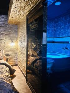 a bathroom with a tub and a bed and a bed and a bath tub at GOLDEN ROCK HOUSE in Ankara