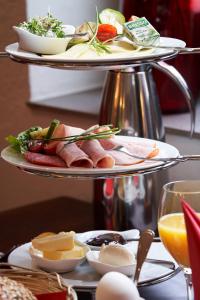 a three tiered plate of food on a table at Boutique Hotel am Markt in Melle