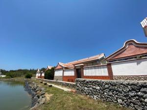 a row of buildings next to a body of water at Murraya Paniculata Villa in Magong