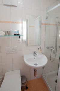 a bathroom with a sink and a toilet and a shower at Hotel Restaurant Post in Bözen