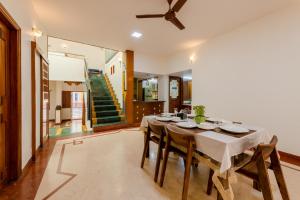 a dining room with a long table and chairs at Villa 9C by Revkeys in Bangalore