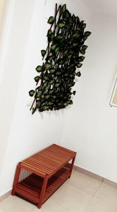 a bench in front of a wall with a plant at Tarancon Suite Exclusivo in Tarancón