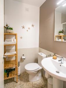 a bathroom with a white toilet and a sink at Empuriabrava Apartaments - nº4 in Empuriabrava