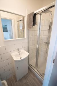 a bathroom with a sink and a shower at Ideal Lodgings in Walkden 