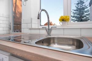 a stainless steel sink in a kitchen with a window at Cowdray Avenue in Colchester