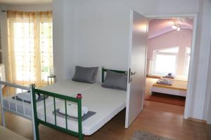 a small bedroom with a bunk bed and a mirror at Holiday Home Uma in Visoko