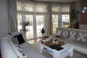 a living room with two white couches and a table at Holiday Home Uma in Visoko