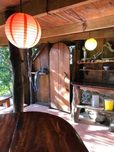 a room with a wooden table and a wooden ceiling at Ocean View rustic cabin in the jungle by the surf in Pavones