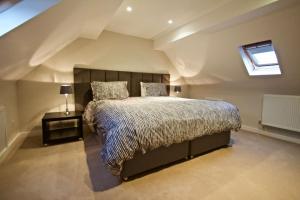 a bedroom with a large bed in a attic at Converted Countryside Barn in Inkpen