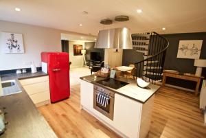 a kitchen with a red refrigerator and a living room at Converted Countryside Barn in Inkpen