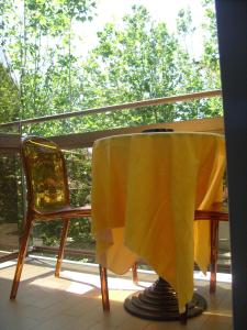 a table with a yellow table cloth on a balcony at Hotel Tiziana in Rimini