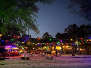 a string of lights at night with tables and chairs at Dream Resort in Koh Rong Island
