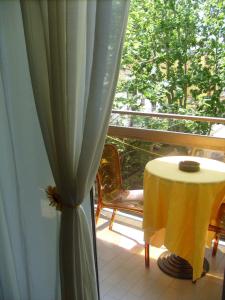 a room with a table and a window with a curtain at Hotel Tiziana in Rimini