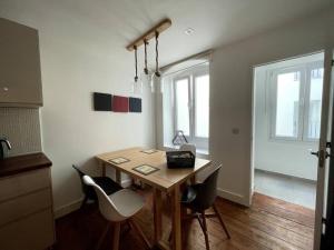 a dining room with a wooden table and chairs at Stylish 2BR contemporary design perfect vacation in Gibraltar +9 photos