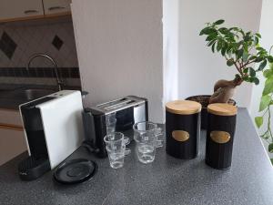 a kitchen counter with a counter top with drinking glasses at Casa Sandra in Villach