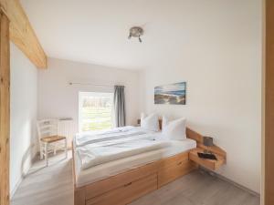 a bedroom with a bed and a window at Gut Vorwerk in Sagard