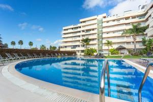 a swimming pool in front of a building at Marina Vilamoura Aquamar 215 VilamouraSun in Vilamoura