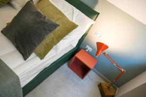 a bedroom with a bed and a red lamp at Casa Ferretti apartment in Brindisi