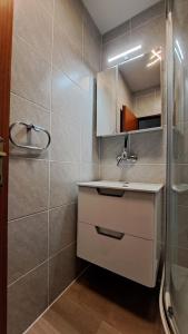 a bathroom with a sink and a shower at Apartment ŠTIZ by the sea with an organized beach in Betina