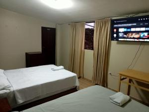 Postel nebo postele na pokoji v ubytování ROARI HOTEL