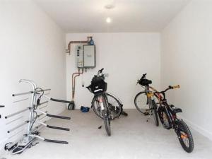 two bikes are parked in a garage at Millwood in Aviemore