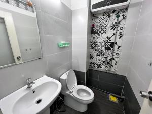 a bathroom with a white toilet and a sink at Little Japan Room 301-Ben Thanh market-D1 in Ho Chi Minh City
