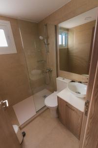 a bathroom with a toilet and a shower and a sink at Chrielka Hotel in Limassol