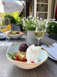 a plate of food on a table with wine glasses at Alt Lohbrügger Hof in Hamburg