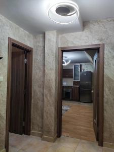 a hallway with two doors and a kitchen at Apart Centar in Plovdiv