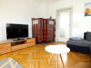 a living room with a flat screen tv and a table at Inviting Holiday Home in Lichtenau with Garden 