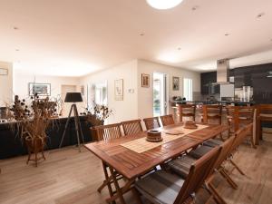 a dining room with a wooden table and chairs at Villa Sainte-Marie-de-Ré, 4 pièces, 6 personnes - FR-1-258-89 in Sainte-Marie-de-Ré