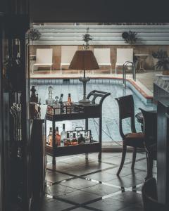 a table in a living room with a swimming pool at Chrielka Hotel in Limassol