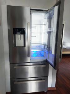 an empty refrigerator with its door open in a room at Sonnige Ferienwohnung bei Familie Köhler in Kappel-Grafenhausen +10 photos