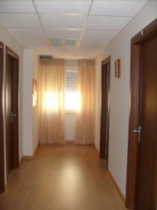a hallway with a room with a window and curtains at Hotel Tiziana in Rimini