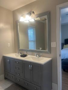 a bathroom with a sink and a mirror at Sweet Home Atlanta in Atlanta