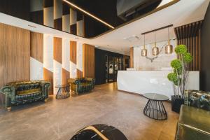 a lobby with two chairs and a table at Bristol Hotel Podgorica in Podgorica