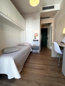 Łóżko lub łóżka w pokoju w obiekcie Hotel Regina