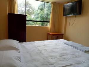 Postel nebo postele na pokoji v ubytování ROARI HOTEL