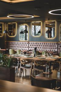 a dining room with wooden tables and chairs at Bristol Hotel Podgorica in Podgorica