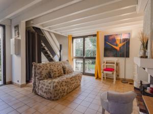 a living room with a couch and a staircase at Holiday Home Le Clos du Golf-2 by Interhome in Cabourg